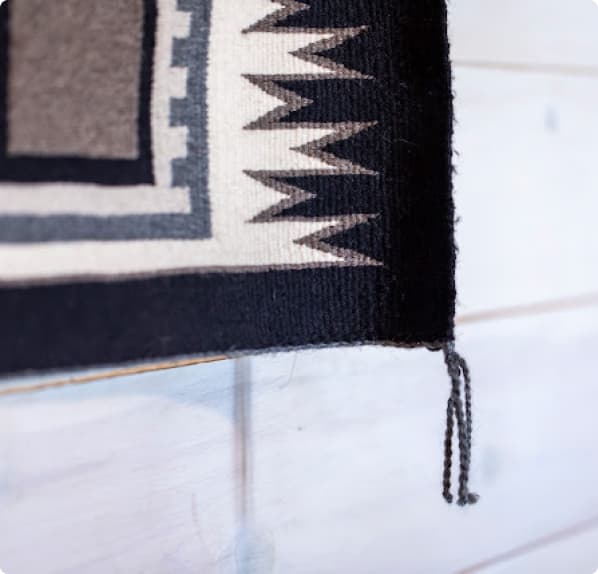 macro photography of a beautiful hand woven black, white and grey native american tapestry with a geometric pattern at trinchera ranch